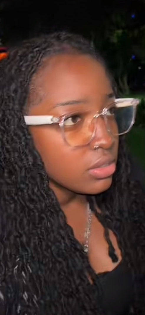 Woman wearing glasses with a dark background